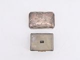 a small silver box with a picture on it and a smaller silver box with a picture on it