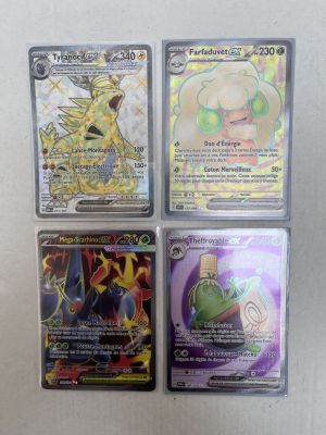 four different pokemon cards are sitting on a white surface