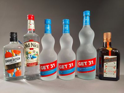 several bottles of alcohol are lined up on a table