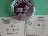 a silver coin on a piece of paper on a table