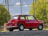 a small red car that is parked in front of a gate