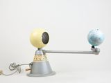 a light that is sitting on a table with a globe on it