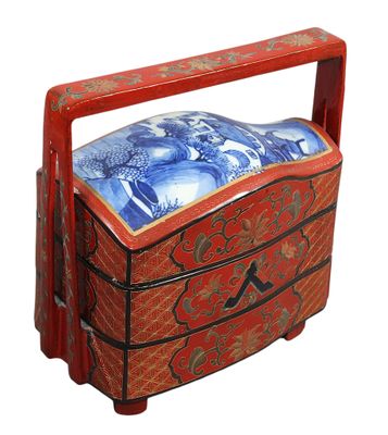 une boîte rouge ornée d'un motif bleu et blanc