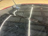 a close up of a car ' s windshield with a sticker on it