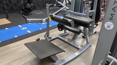 a gym room with a bench, weights, and other equipment