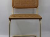 a brown and white chair sitting on top of a white floor