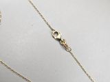 a gold chain with a heart pendant on top of it