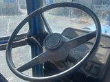 a steering wheel of a bus that is sitting in a bus
