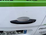 a green and white bus parked on the side of the road