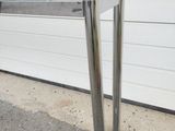 a glass table with a metal base and a glass top