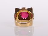 gold ring with a pink stone in the middle of it
