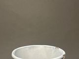 a white vase that is sitting on a table