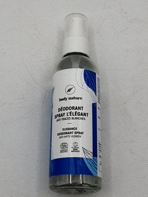 un flacon de déodorant en spray posé sur une table