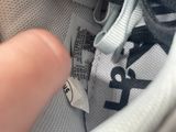 a close up of a person ' s shoe with a tag on it