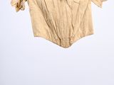 an image of a shirt hanging on a hanger in a room