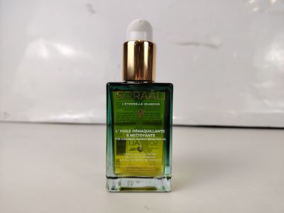a close up of a bottle of oil sitting on a table