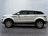 the white range rover is parked on the concrete floor