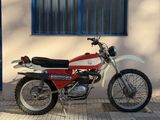 a red and white motorcycle parked in front of a building
