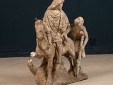 statue of a man riding a horse with a boy on it