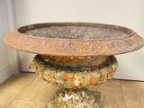 a close up of a stone pedestal with a bowl on top of it