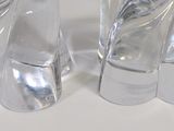 pair of clear glass elephant figurines sitting on a white surface