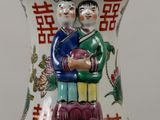 a vase with a couple of people on it
