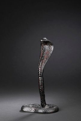an image of a black cobra statue on a dark background