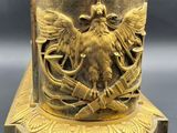 bronze statue of a man and woman on a pedestal with a bird on it