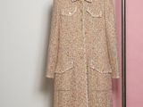 a close up of a coat hanging on a hanger in a room