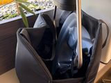 a black bag with a silver handle and a black bag with a silver handle
