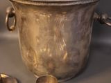 a silver bowl with spoons and spoons on a table
