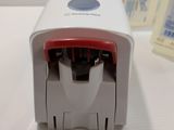 a small white and red stamper on a white table
