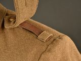 a close up of a brown jacket with a brown belt