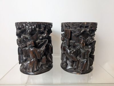 two vases that are sitting on a glass table