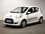 a small white car that is parked in a garage