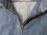 a close up of a blue jean jacket with a label on it