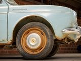 an old car that is parked in a garage