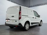 the rear end of a white van parked inside of a building