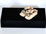 a black box with a pair of baby shoes on it