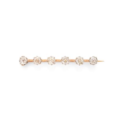 une photo d'une broche en forme de lingot, en or et diamants