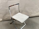 a white chair that is next to a white wall