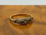 a close up of a gold ring on a wooden table