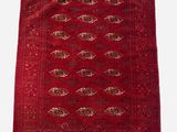 a red rug with fringes on a white background