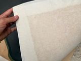 a person that is holding a piece of paper in their hand