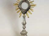 a silver and gold statue with a cross on top of it