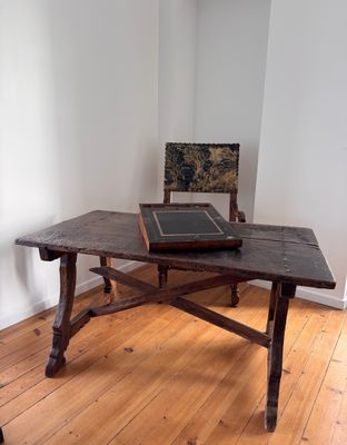 a wooden table with a black tile on top of it