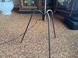 a lamp that is on a tripod in a room