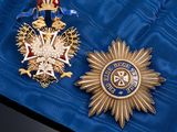 two medals that are laying on a blue cloth