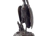 a statue of a bird that is sitting on top of a rock