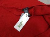 the label on a red sweater is attached to the back of a red sweater